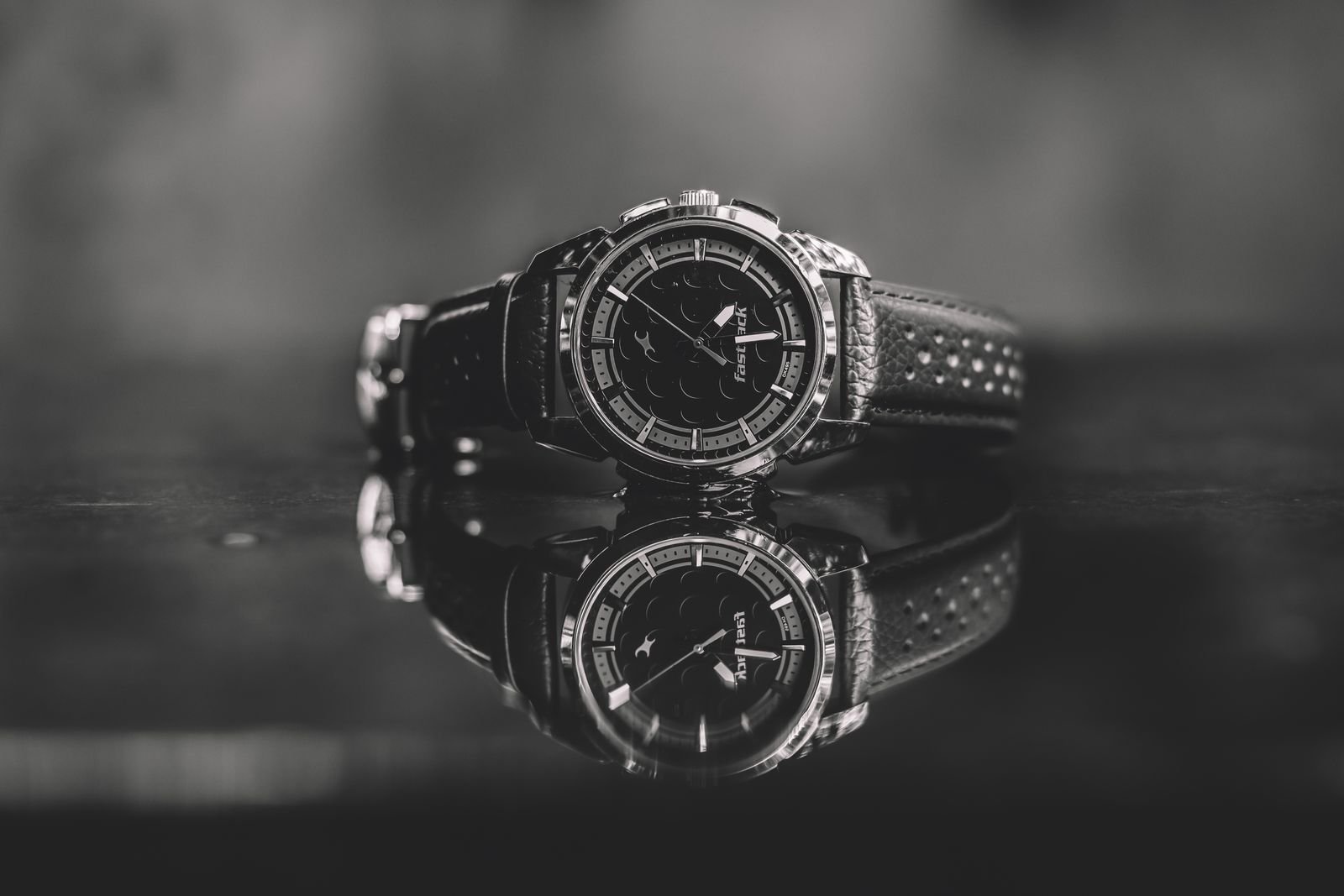 Black mechanical wristwatch examined while learning how to spot a fake Omega Planet Ocean