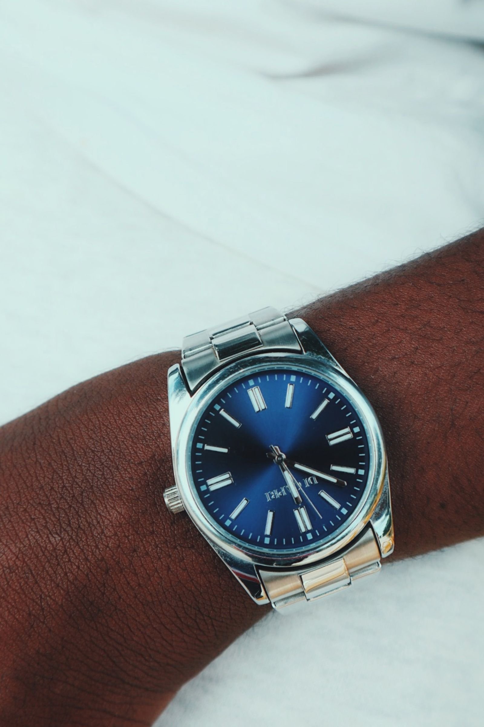 Blue-dial automatic wristwatch illustrating Omega Caliber 8900 winder settings