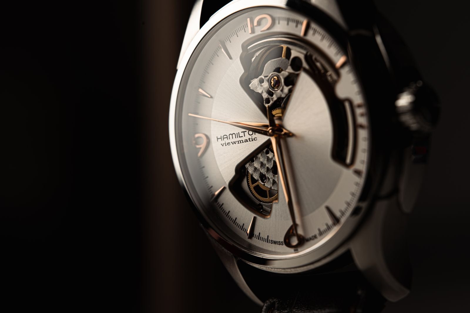 Silver and black luxury wristwatch photographed in close-up