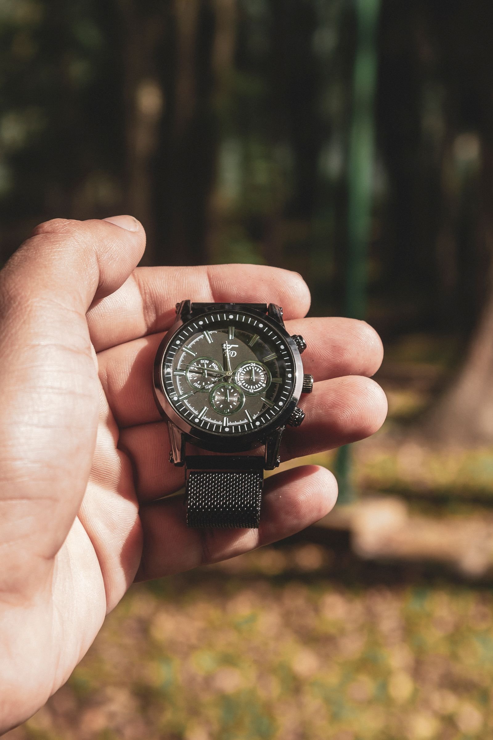 Mechanical wristwatch held carefully while its winding feel is checked