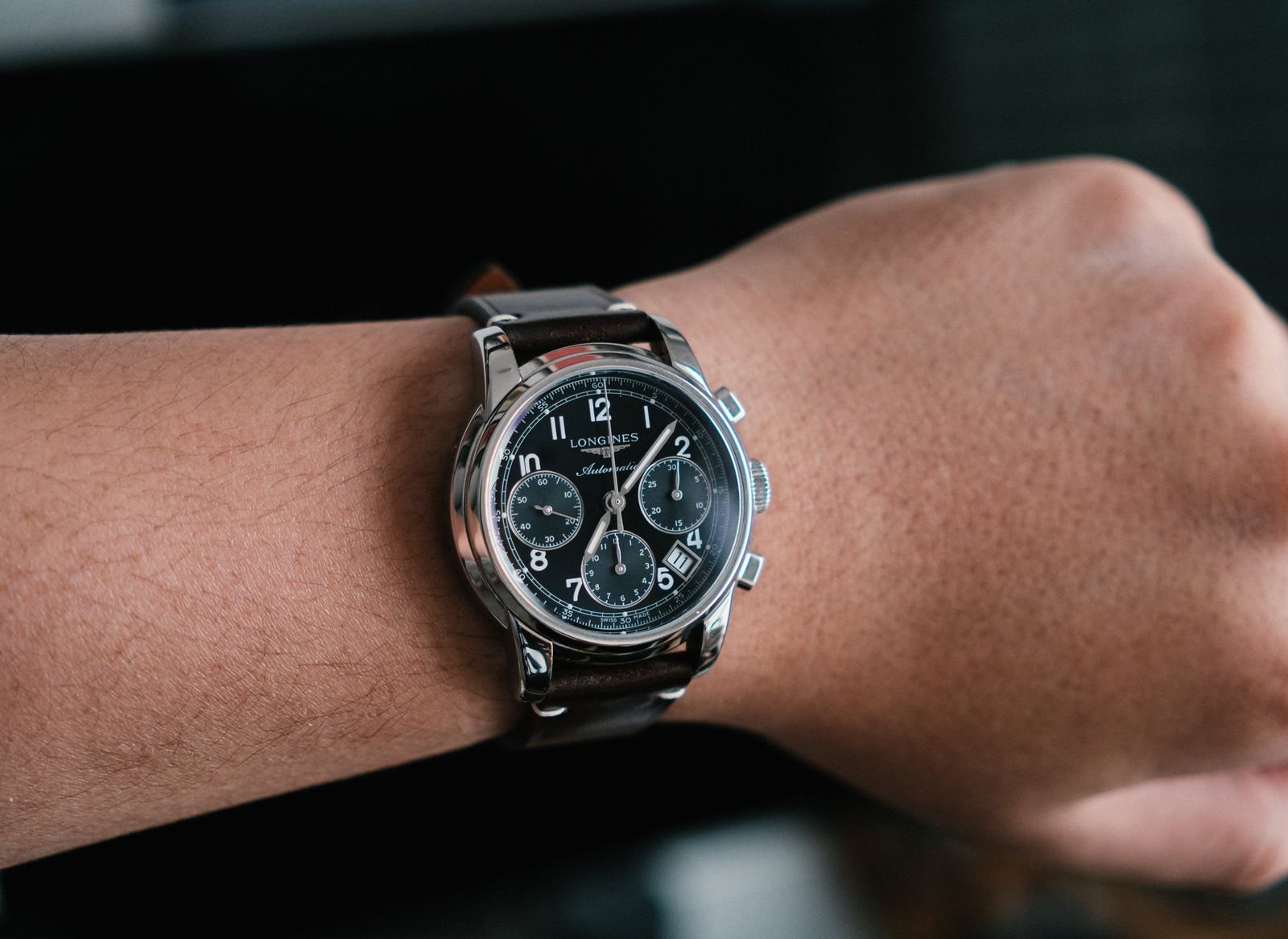 Luxury stainless steel chronograph watch standing upright on display