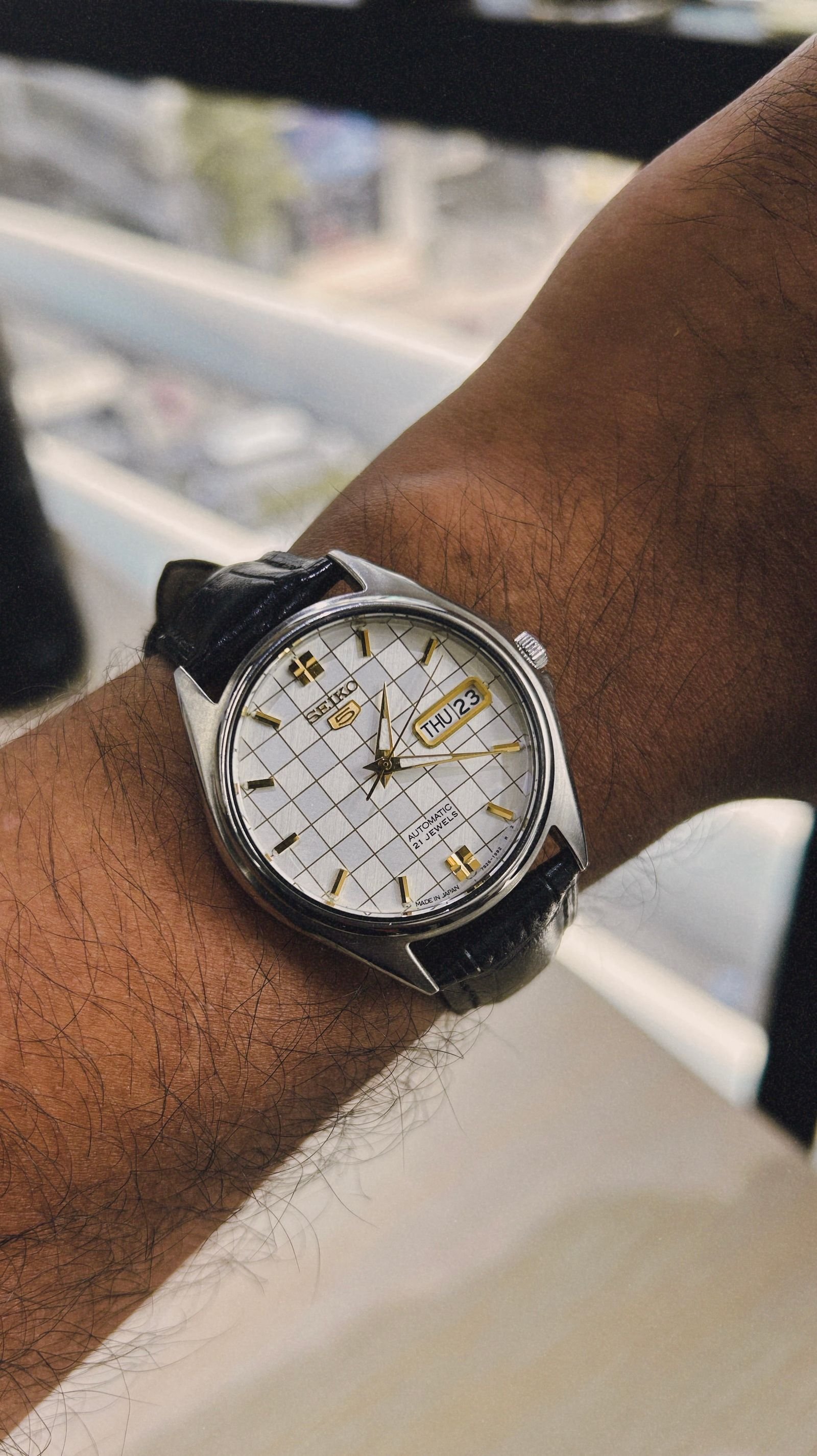 Person checking an automatic wristwatch before a controlled wear test