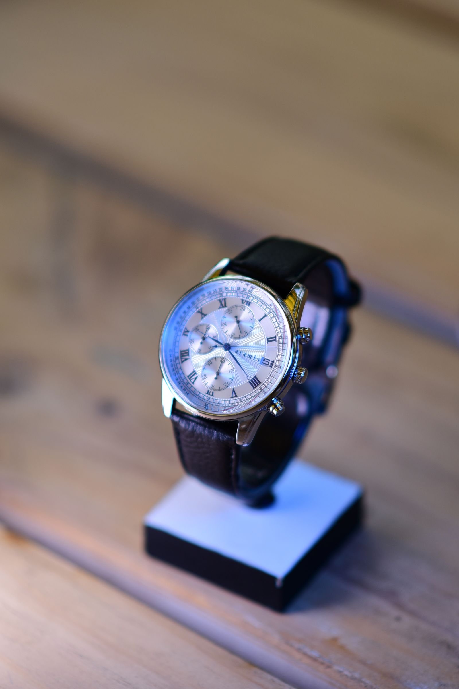 Luxury chronograph with leather strap used to examine dial printing and proportions
