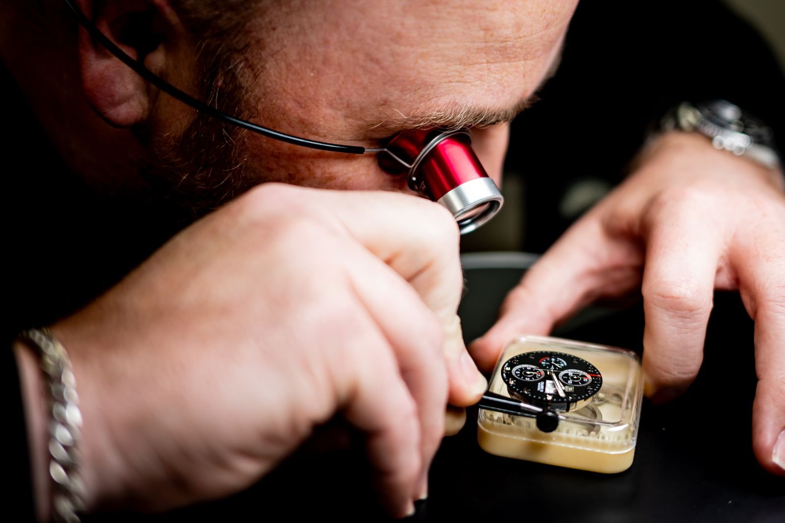 Watchmaker inspecting a timepiece during professional IWC authentication