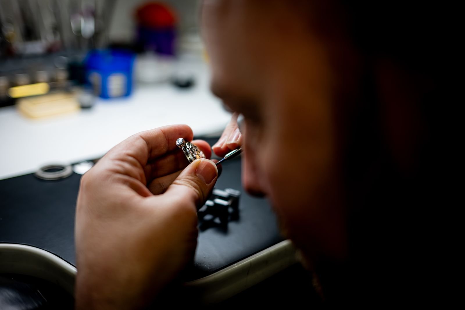 Watchmaker servicing an intricate movement with precision tools