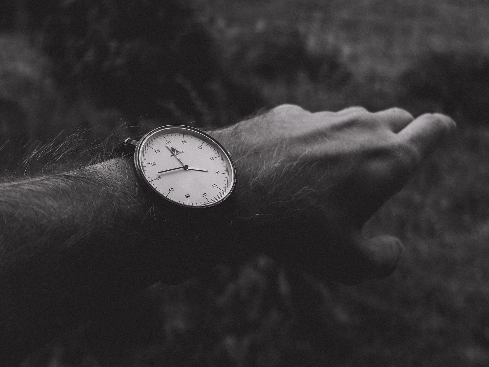 Analog mechanical watch shown in a vertical wrist position