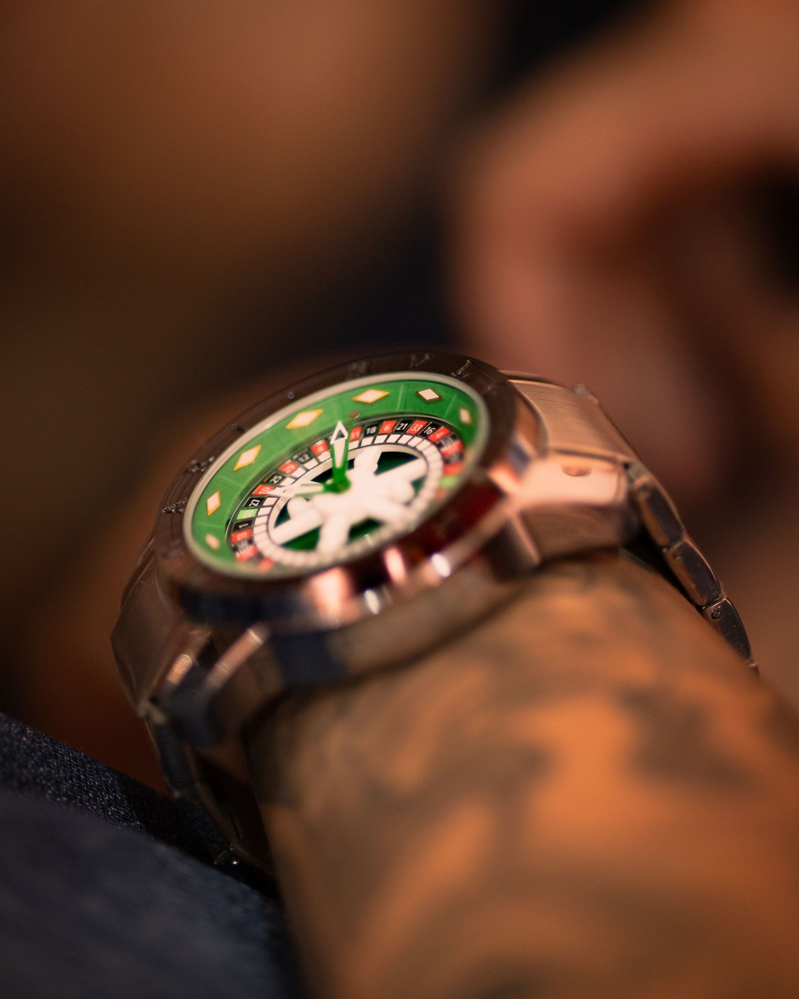 Macro view of a polished luxury watch case, dial and bracelet