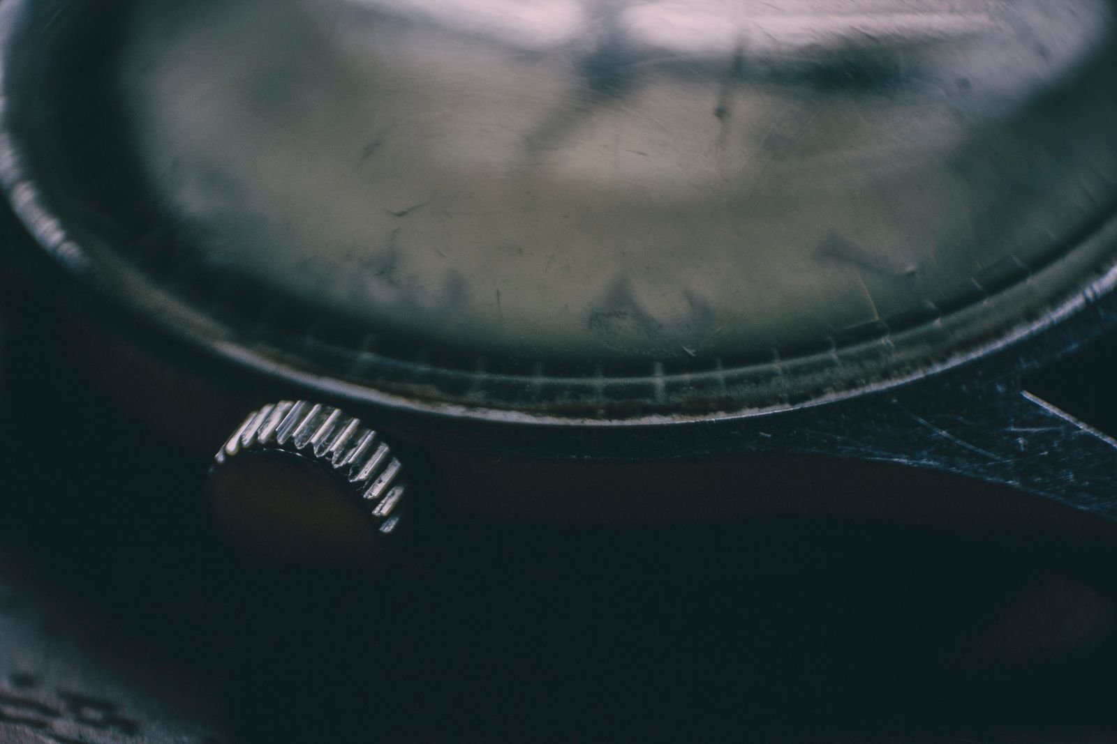 Close-up of a vintage wristwatch crown and case