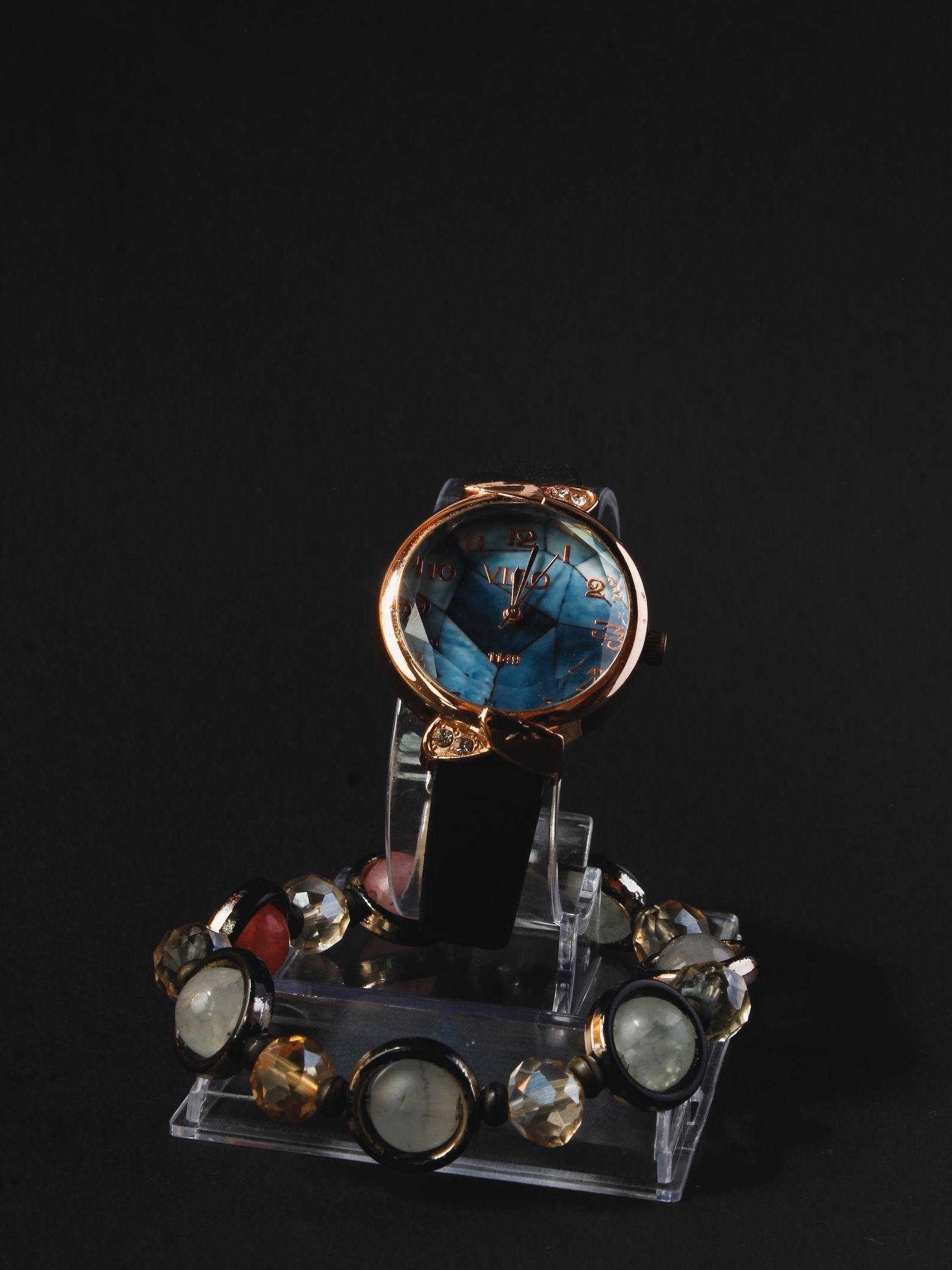 Luxury wristwatch crystal viewed under controlled light before polishing