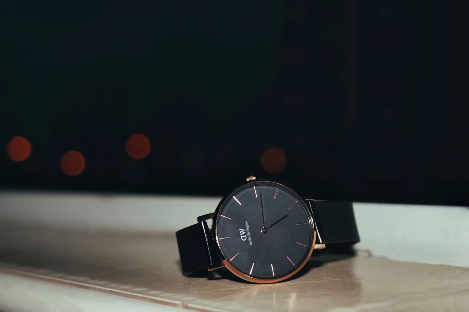 Black wristwatch dial under directional light for printing and lume inspection