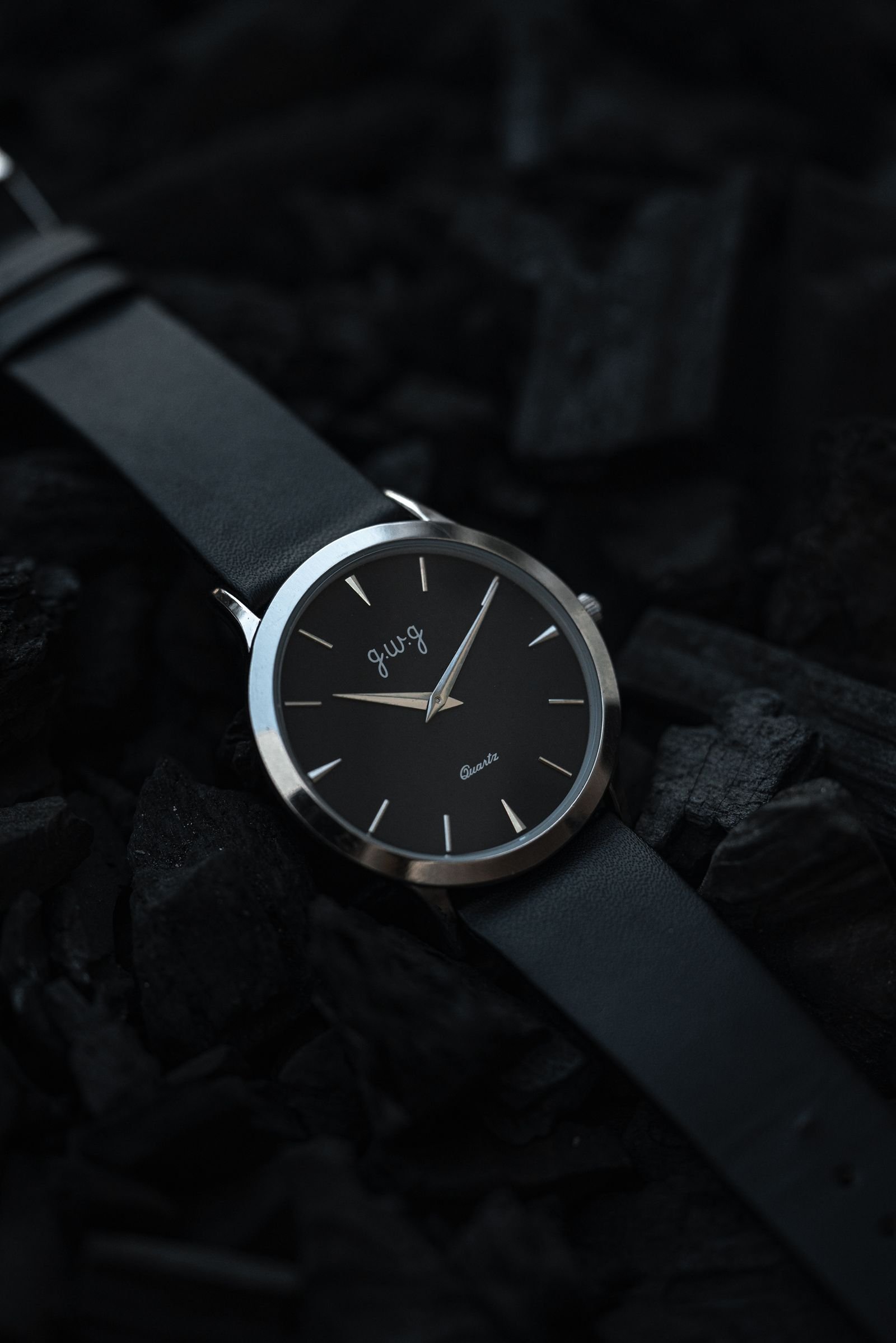 Dark-dial wristwatch photographed under low light for a lume test