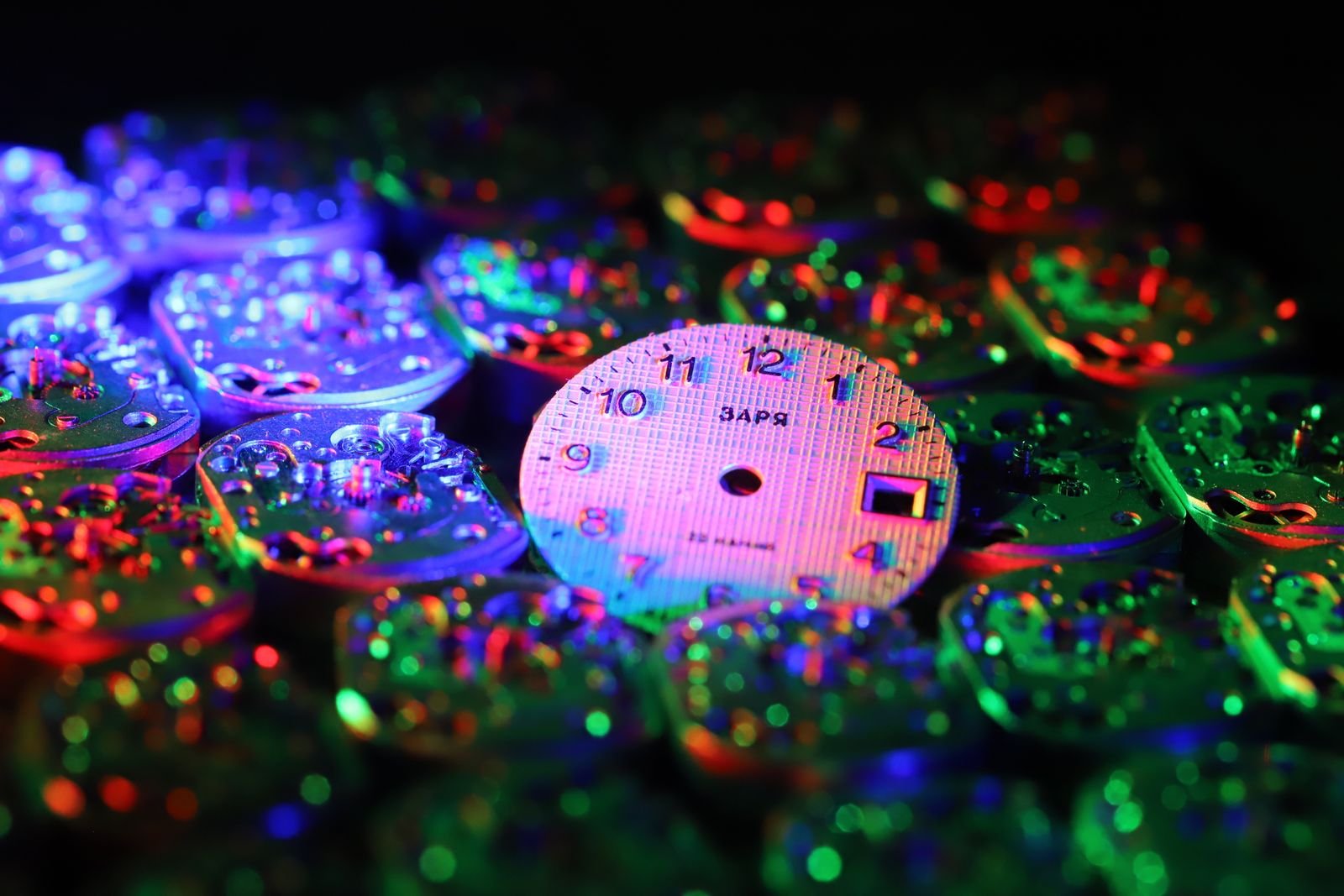 Watch dial and movement components illuminated in a dark setting