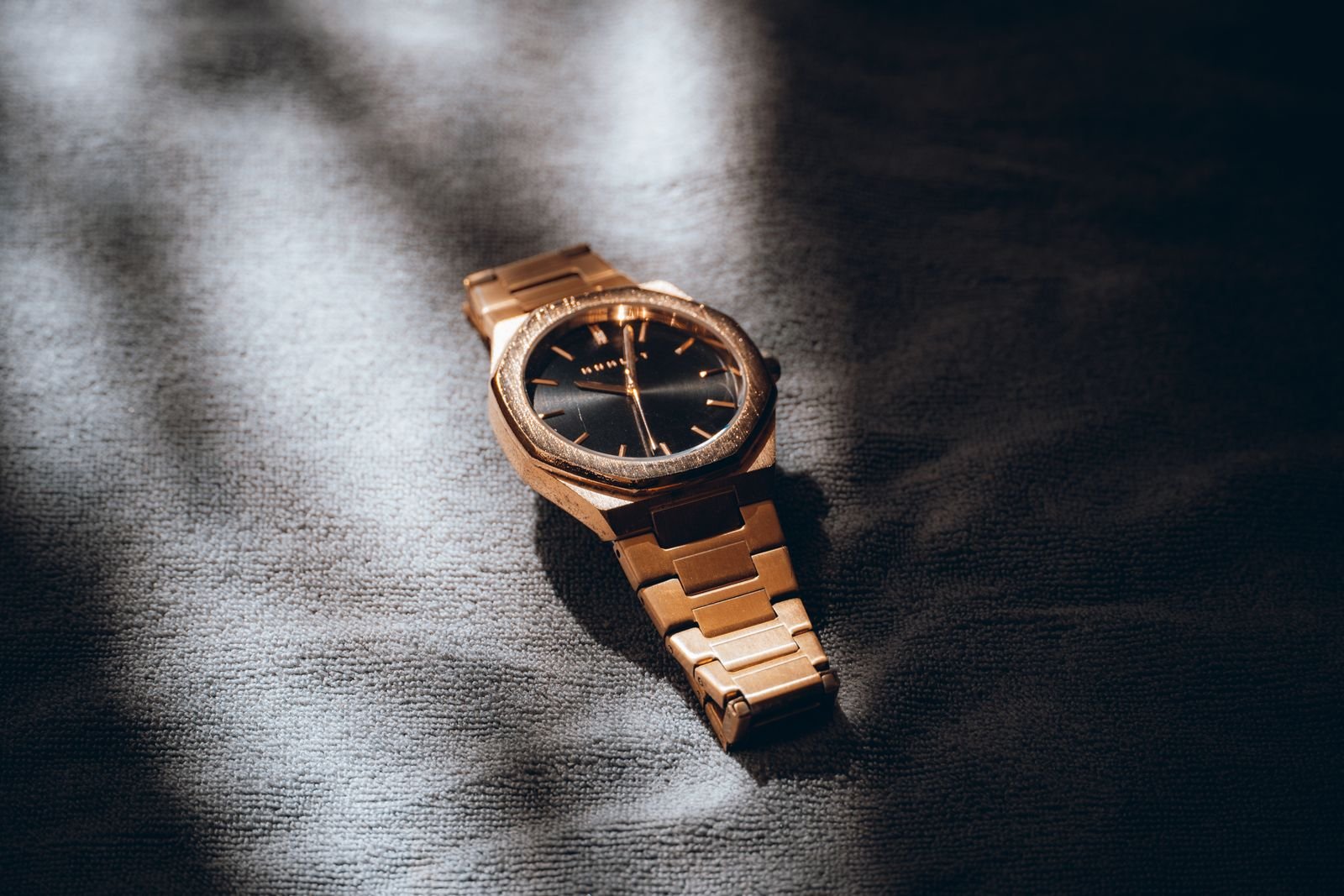 Watch dial under directional light during an inspection for uneven lume