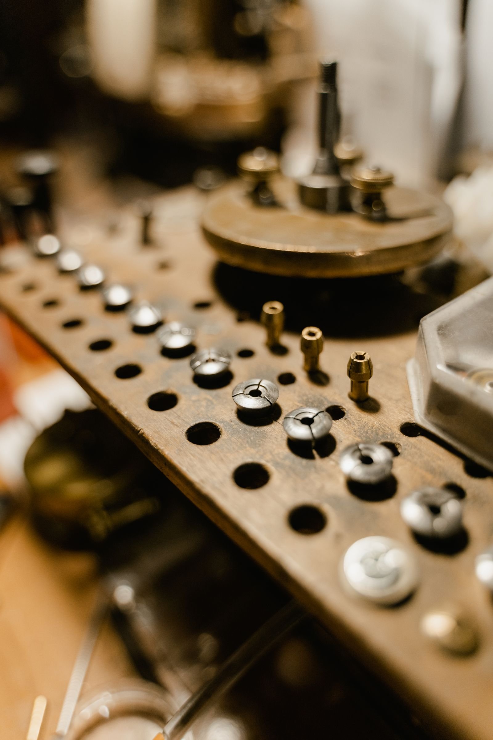Small watch gears and repair components organized in a professional workshop