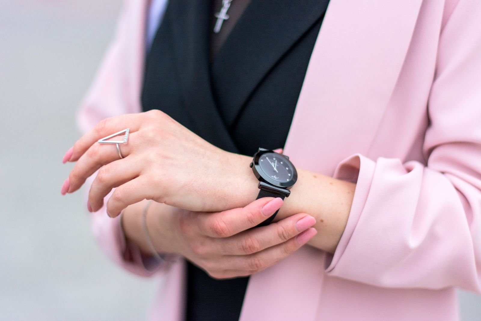 Woman adjusting a wristwatch after removing it from a watch winder