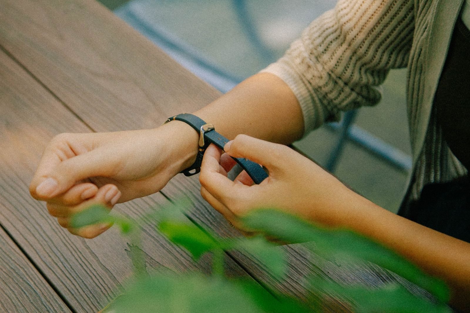 Person handling a wristwatch carefully while checking crown feel and rotor behavior