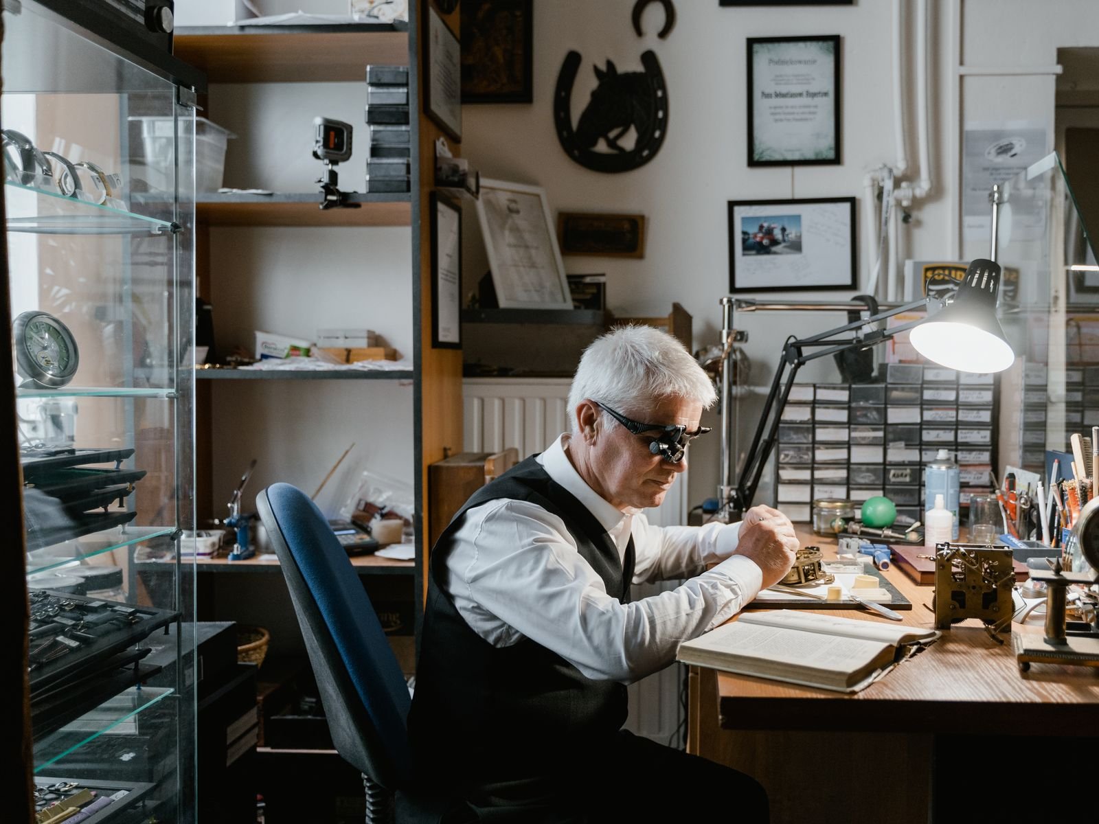 Professional watchmaker diagnosing the motion work of a mechanical watch