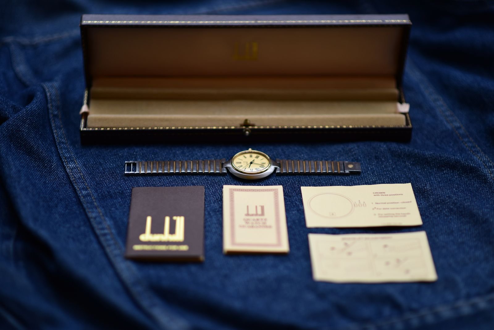 Pre-owned wristwatch displayed with box and documents for provenance review
