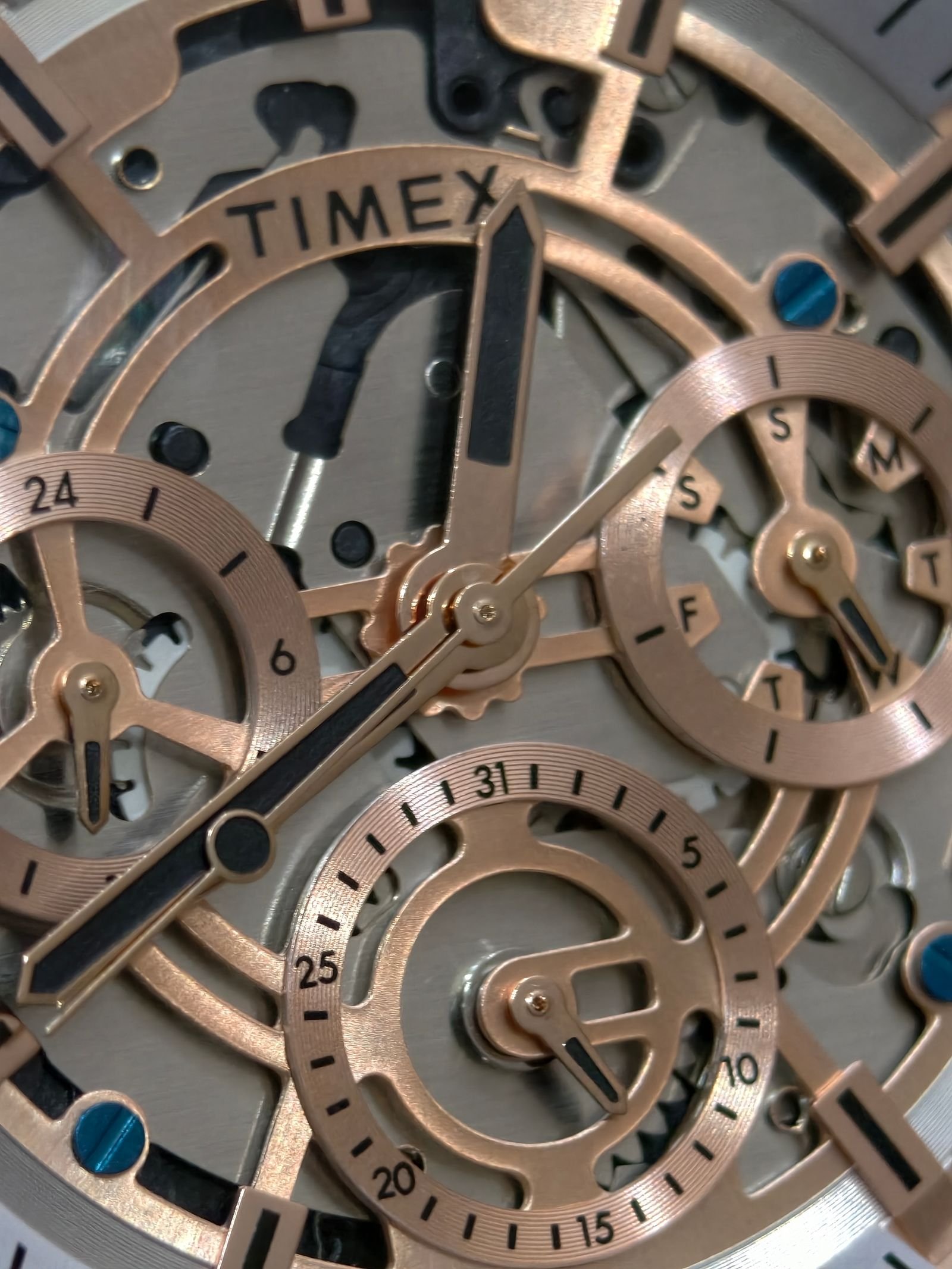 Open mechanical watch showing the balance assembly and regulating components
