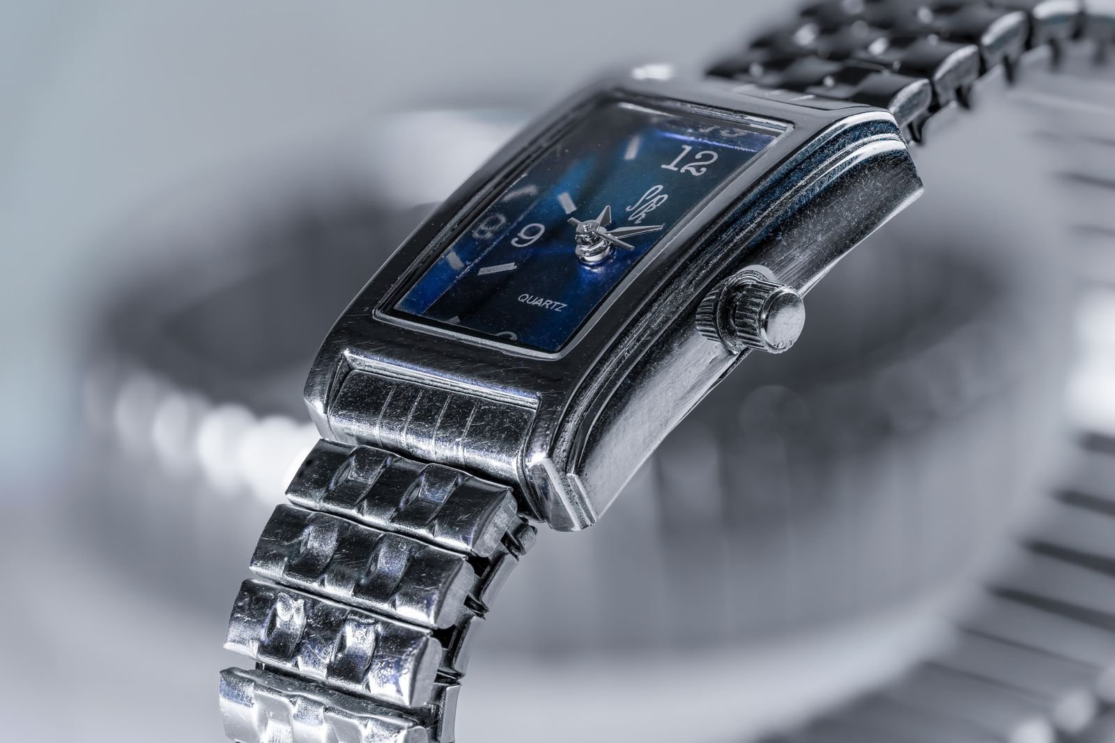 Close view of a steel watch used to compare dial printing bezel alignment and case finishing