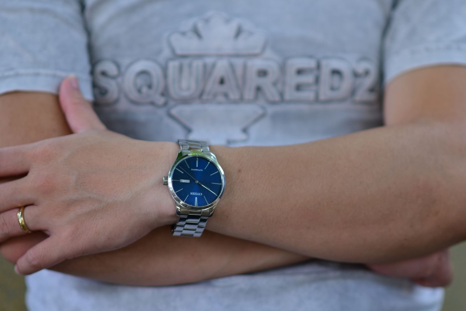 Stainless steel wristwatch inspected closely before professional movement authentication