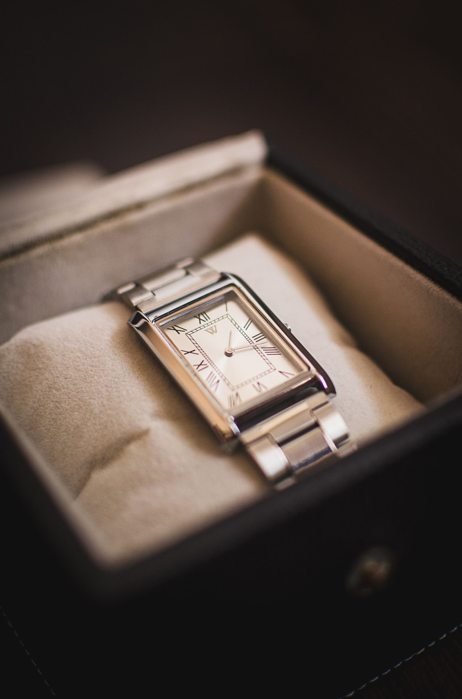 Pre-owned wristwatch presented with a box while paperwork and provenance are checked
