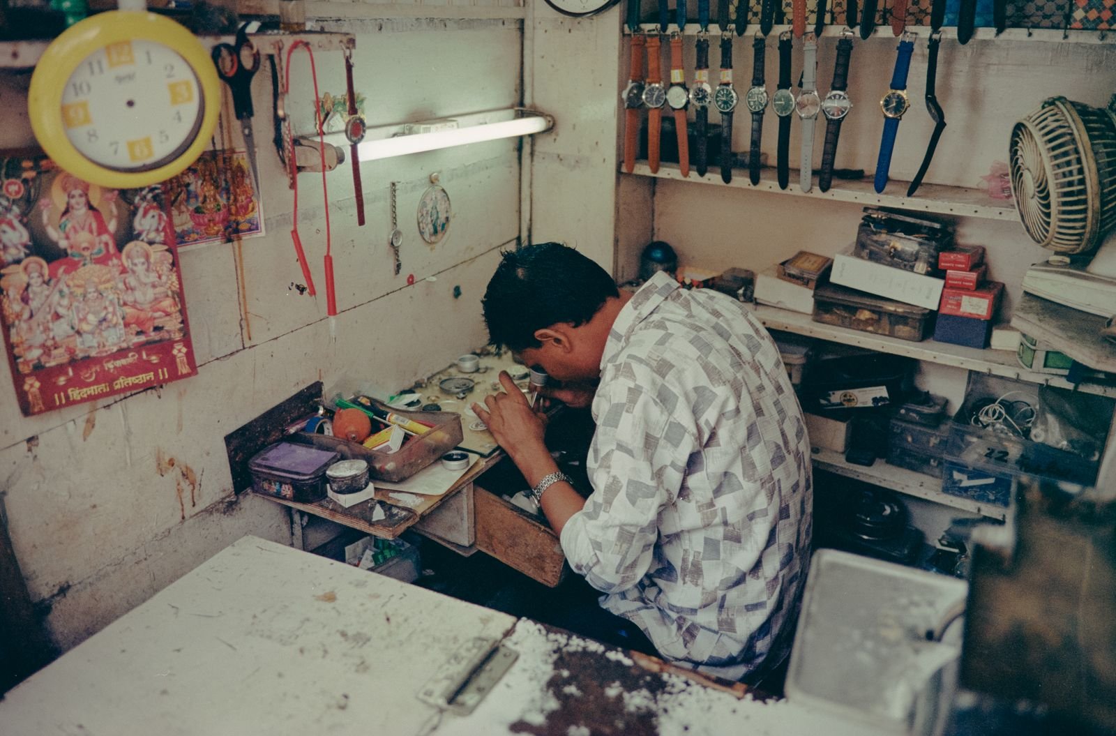 Watchmaker at a workbench prepared to diagnose an abnormal winding sound