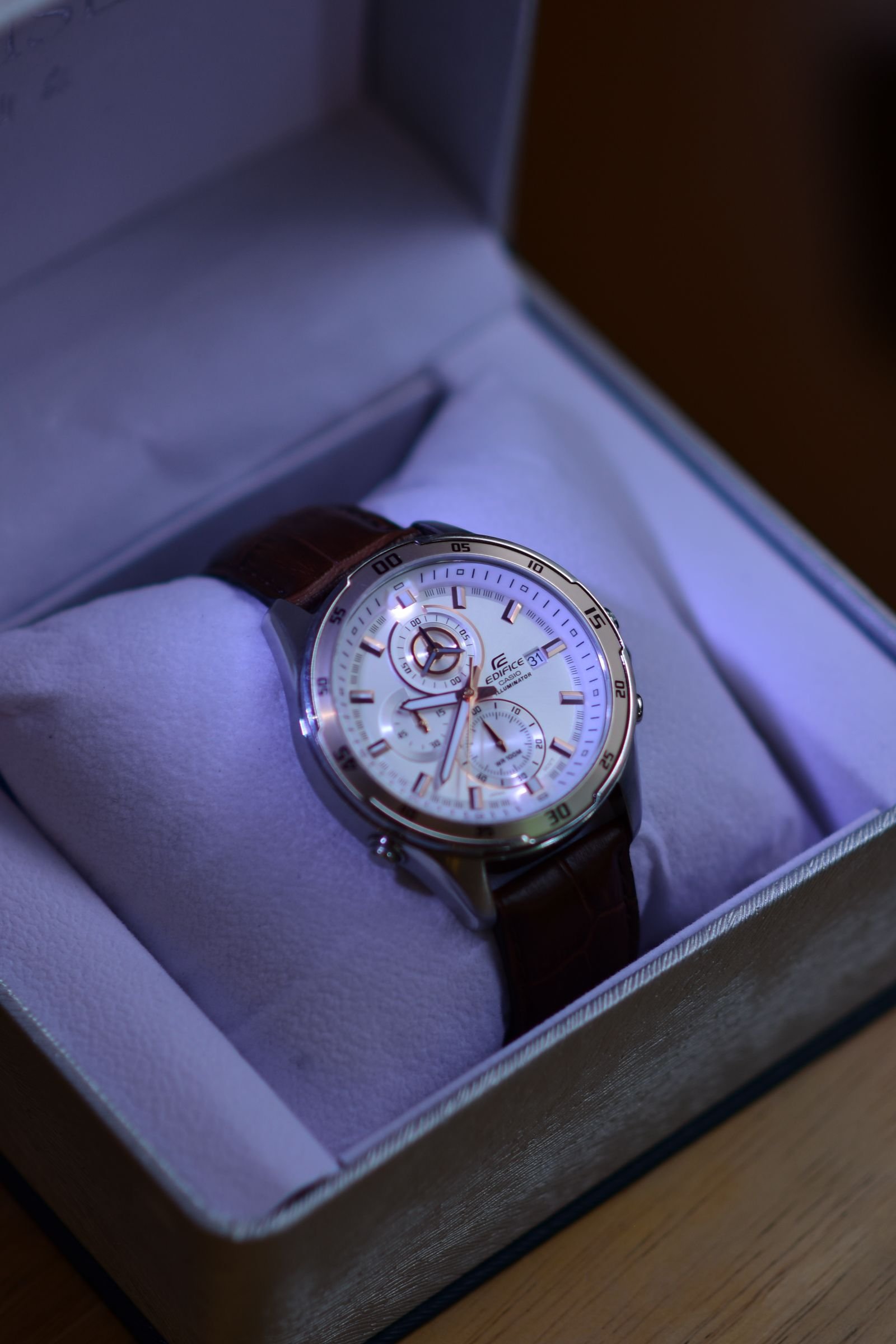 Tudor MT5813 winder settings represented by a silver chronograph displayed in a watch box