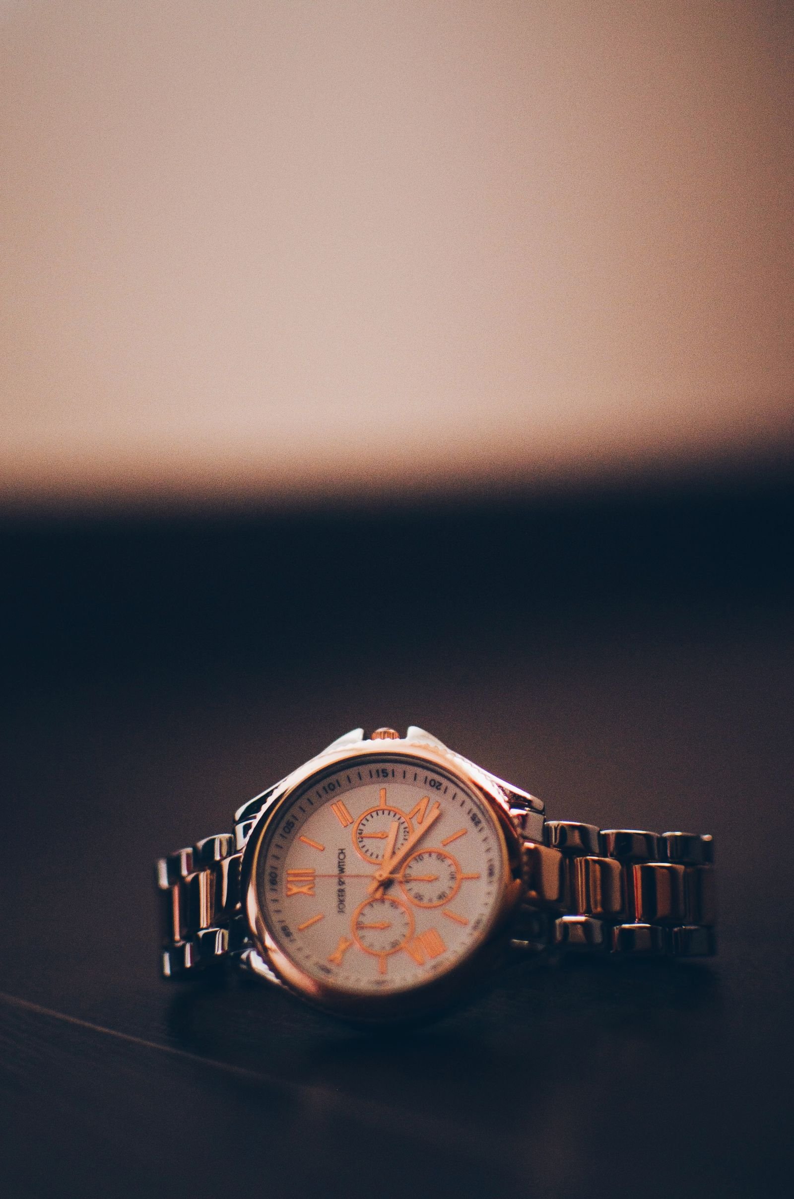 Mechanical wristwatch photographed in low light to represent checking reserve after a multi-day winder test